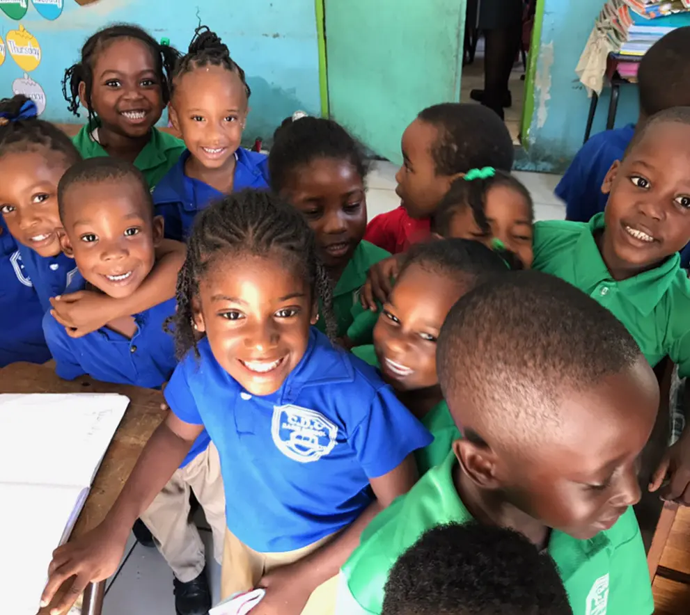 A photo of smiling children at a school in Jamaica where this oral surgeon n Westchester County NY provides humanitarian dental services.